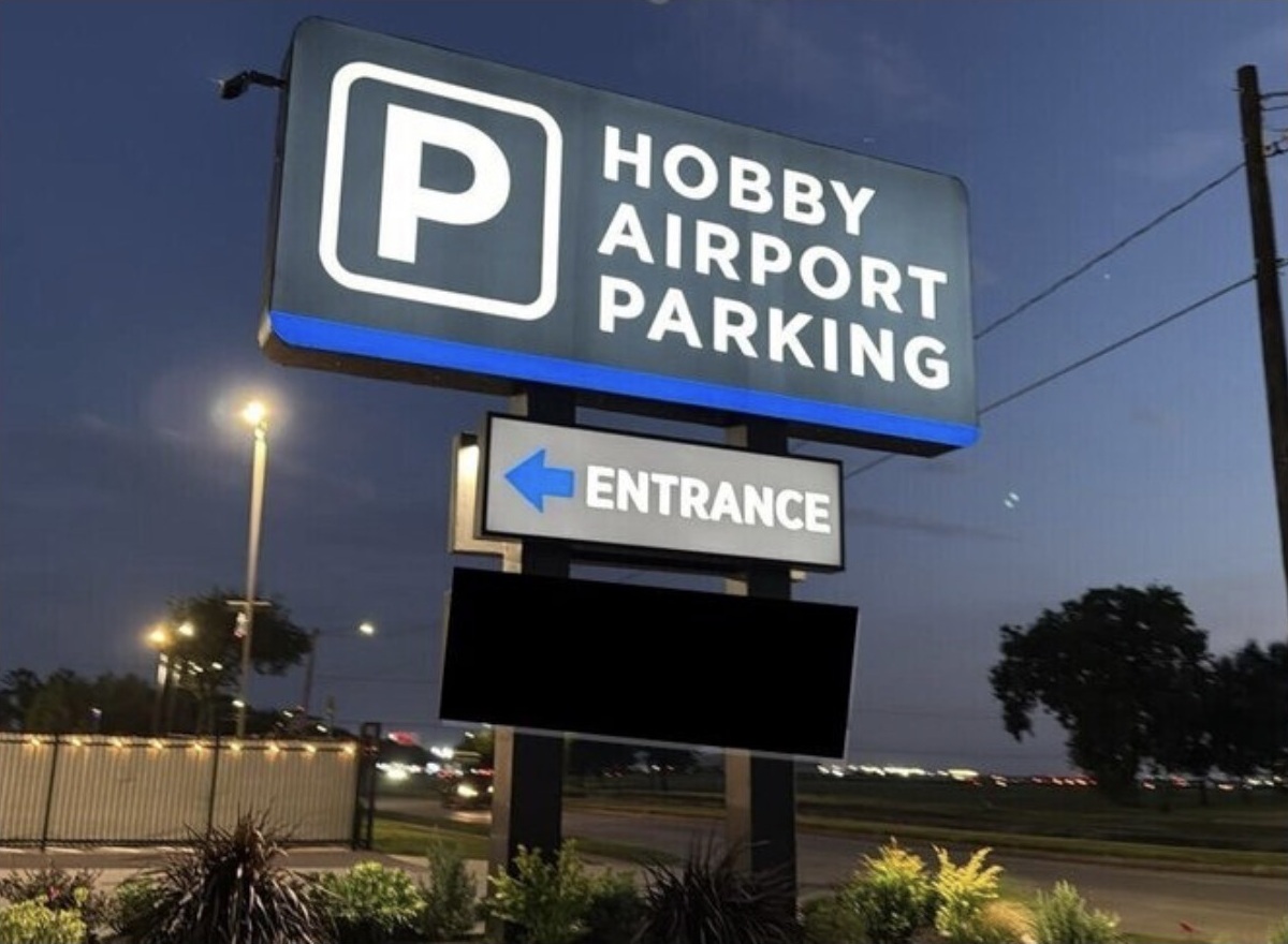 Hobby Airport Parking entrance sign at dusk